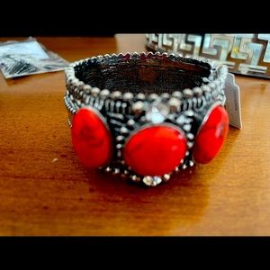 Silver tone cuff bracelet with red stones. Tags still present NEW